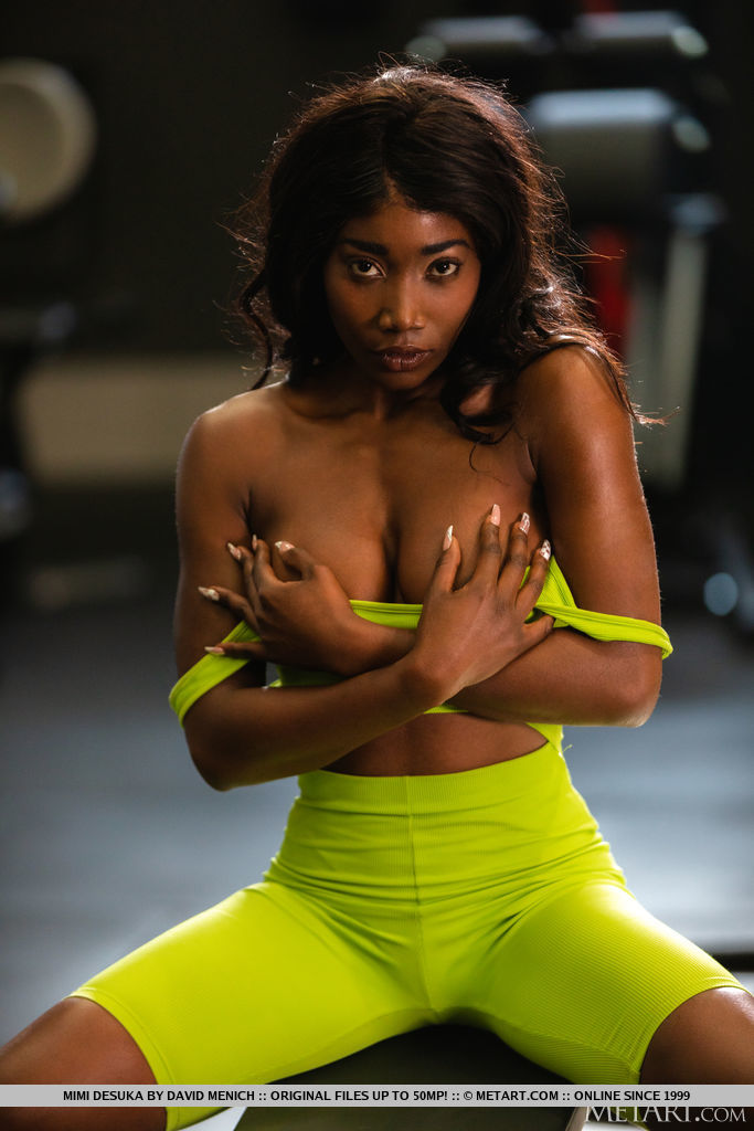 Athletic Black beauty Mimi Desuka bares her lovely breasts, nipples stiffening at the sudden exposure. She reveals her perfect, gym-honed ass as she strips down to her sneakers, flaunting her fit physique.