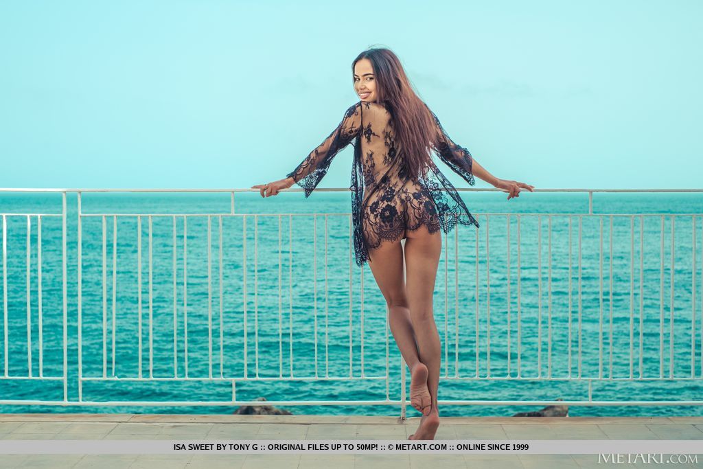Isa Sweet  completes the perfect morning view as she poses in her exquisite birthday suit on a balcony overlooking the ocean.